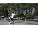 Personal swinging a tennis racket during a doubles tennis match at 415 Ocean Creek Dr. # 2373, Myrtle Beach, SC 29572