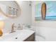 Coastal-themed bathroom featuring a surfboard painting and modern fixtures at 4445 Kingsport Rd. # 303, Little River, SC 29566
