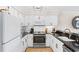 Updated kitchen with white cabinets, stainless steel appliances, and granite countertops at 4445 Kingsport Rd. # 303, Little River, SC 29566