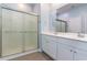 Bright bathroom with white vanity, sliding glass shower door, and frosted glass detail at 509 Covewood Ct., Longs, SC 29568