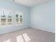 Empty bedroom with light blue walls, gray carpet, and shuttered windows at 509 Covewood Ct., Longs, SC 29568
