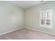 Empty bedroom with light green walls, gray carpet, and a shuttered window at 509 Covewood Ct., Longs, SC 29568