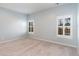 Spacious bedroom with plush carpeting and two large windows with shutters at 509 Covewood Ct., Longs, SC 29568