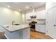 Stylish kitchen with white cabinetry, stainless steel appliances, and a granite-topped island at 509 Covewood Ct., Longs, SC 29568