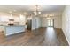 Bright open kitchen and dining area with wood-look flooring and sliding glass doors at 509 Covewood Ct., Longs, SC 29568
