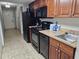 Kitchen with black appliances, wood cabinets and tile floors at 5200 N Ocean Blvd. # 932, Myrtle Beach, SC 29577