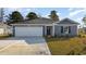 Charming blue two-story home with a two-car garage and landscaped yard at 527 Firouz Dr, Longs, SC 29568