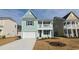 Charming two-story home with a mint green exterior, white garage door, and inviting front porch at 547 Slaty Dr., Myrtle Beach, SC 29588
