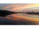 Stunning waterfront sunset with colorful reflection and distant cityscape at 547 Slaty Dr., Myrtle Beach, SC 29588