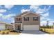 Charming two-story home with a welcoming front porch and landscaped yard at 620 Grateful Dr., Little River, SC 29566