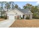 Front exterior of a house with a beige facade and brick accents at 785 Rambler Ct., Myrtle Beach, SC 29579