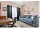 Cozy home office or den with a comfortable couch, desk, and natural light at 785 Rambler Ct., Myrtle Beach, SC 29579