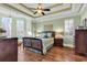 Elegant main bedroom with tray ceiling, wood floors, and large windows at 8105 Hollings Ct., Myrtle Beach, SC 29588