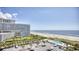 Coastal aerial view showcasing the beach, ocean, resort, pool, and parking area at 9820 Queensway Blvd. # 903, Myrtle Beach, SC 29572