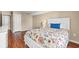 Bedroom featuring hardwood floors, white furniture, and a floral comforter at 9820 Queensway Blvd. # 903, Myrtle Beach, SC 29572