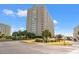 Exterior view of a high-rise condominium building with balconies and landscaping at 9820 Queensway Blvd. # 903, Myrtle Beach, SC 29572