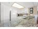 White kitchen with granite counters and plenty of storage at 9820 Queensway Blvd. # 903, Myrtle Beach, SC 29572