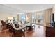 Living room with wooden floors, a couch, and sliding glass doors to the balcony at 9820 Queensway Blvd. # 903, Myrtle Beach, SC 29572