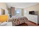 Inviting main bedroom with wood floors, white furnishings, and ocean views at 9820 Queensway Blvd. # 903, Myrtle Beach, SC 29572