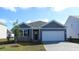 Charming single-story home with blue siding and a white garage door at 1176 Maxwell Dr., Little River, SC 29566