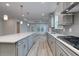 Bright, open kitchen with island, gray shaker cabinets, and ample counter space at 1310 Crested Iris Way, North Myrtle Beach, SC 29582