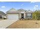 Charming one-story house with stone accents and a two-car garage at 144 Bucky Loop, Murrells Inlet, SC 29576