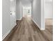 Empty hallway with wood-style flooring, and carpet in the rooms leading off from the hall at 1518 Cherrystone Loop, Conway, SC 29526