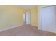 Yellow bedroom with closet and door to another room at 2555 Mount Olive Rd., Loris, SC 29569