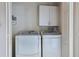 Compact laundry room with washer and dryer and storage cabinets at 2555 Mount Olive Rd., Loris, SC 29569