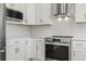 Modern kitchen features stainless steel appliances and white shaker cabinets at 301 Conchal Ct., Murrells Inlet, SC 29576