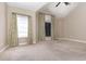 Bedroom with vaulted ceiling, carpet, and windows with curtains at 305 Rung Rd. # 5, Myrtle Beach, SC 29588