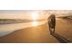 Golden retriever enjoys a sunset stroll on the sandy beach at 3413 Cove Side Ct., North Myrtle Beach, SC 29582