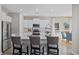 Bright kitchen with white cabinets, stainless steel appliances, a kitchen island, and bar seating at 3413 Cove Side Ct., North Myrtle Beach, SC 29582