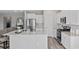 Stylish kitchen with stainless steel appliances, white cabinets, granite counters, and a large island at 3413 Cove Side Ct., North Myrtle Beach, SC 29582