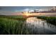 Tranquil marsh view at sunset with tall grasses and reflections in the calm water at 3413 Cove Side Ct., North Myrtle Beach, SC 29582