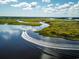 Boat navigates a scenic waterway surrounded by vibrant green marshes at 3413 Cove Side Ct., North Myrtle Beach, SC 29582