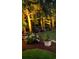 Evening view of a well-lit backyard with colorful hydrangeas and other plantings at 4577 Fringetree Dr., Murrells Inlet, SC 29576