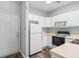 Kitchen featuring white cabinets, black appliances, and light countertops at 476 River Oaks Dr. # 64E, Myrtle Beach, SC 29579