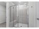 Walk-in shower with gray tile, glass door, and built-in seat at 4795 Hopespring St., Myrtle Beach, SC 29579