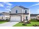 Two-story home with white siding, stone accents, and a one-car garage at 4795 Hopespring St., Myrtle Beach, SC 29579