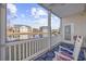 Balcony with rocking chairs, overlooking a pond and neighboring houses at 4924 Pond Shoals Ct. # 101, Myrtle Beach, SC 29579