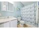 Bathroom with white vanity, toilet, and a blue shower curtain at 4924 Pond Shoals Ct. # 101, Myrtle Beach, SC 29579