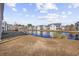 Community pond with grassy banks and townhouses at 4924 Pond Shoals Ct. # 101, Myrtle Beach, SC 29579