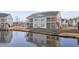 Exterior view of a multi-story building with balconies, next to a pond at 4924 Pond Shoals Ct. # 101, Myrtle Beach, SC 29579