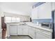 Bright kitchen with white cabinets, light countertops, and stainless steel appliances at 4924 Pond Shoals Ct. # 101, Myrtle Beach, SC 29579
