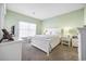 Main bedroom with green walls, a white bed, and matching nightstands at 4924 Pond Shoals Ct. # 101, Myrtle Beach, SC 29579