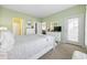 Main bedroom with green walls, a bed, and a door leading to a balcony at 4924 Pond Shoals Ct. # 101, Myrtle Beach, SC 29579