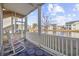 Screened porch with rocking chairs, overlooking a pond and neighboring houses at 4924 Pond Shoals Ct. # 101, Myrtle Beach, SC 29579
