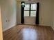 Empty bedroom with wood-look flooring and a colorful hanging lamp at 5001 Little River Rd. # W109, Myrtle Beach, SC 29577