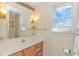 Bathroom with wooden vanity, a mirror, and a window with blinds at 5080 Forest Dr., Loris, SC 29569